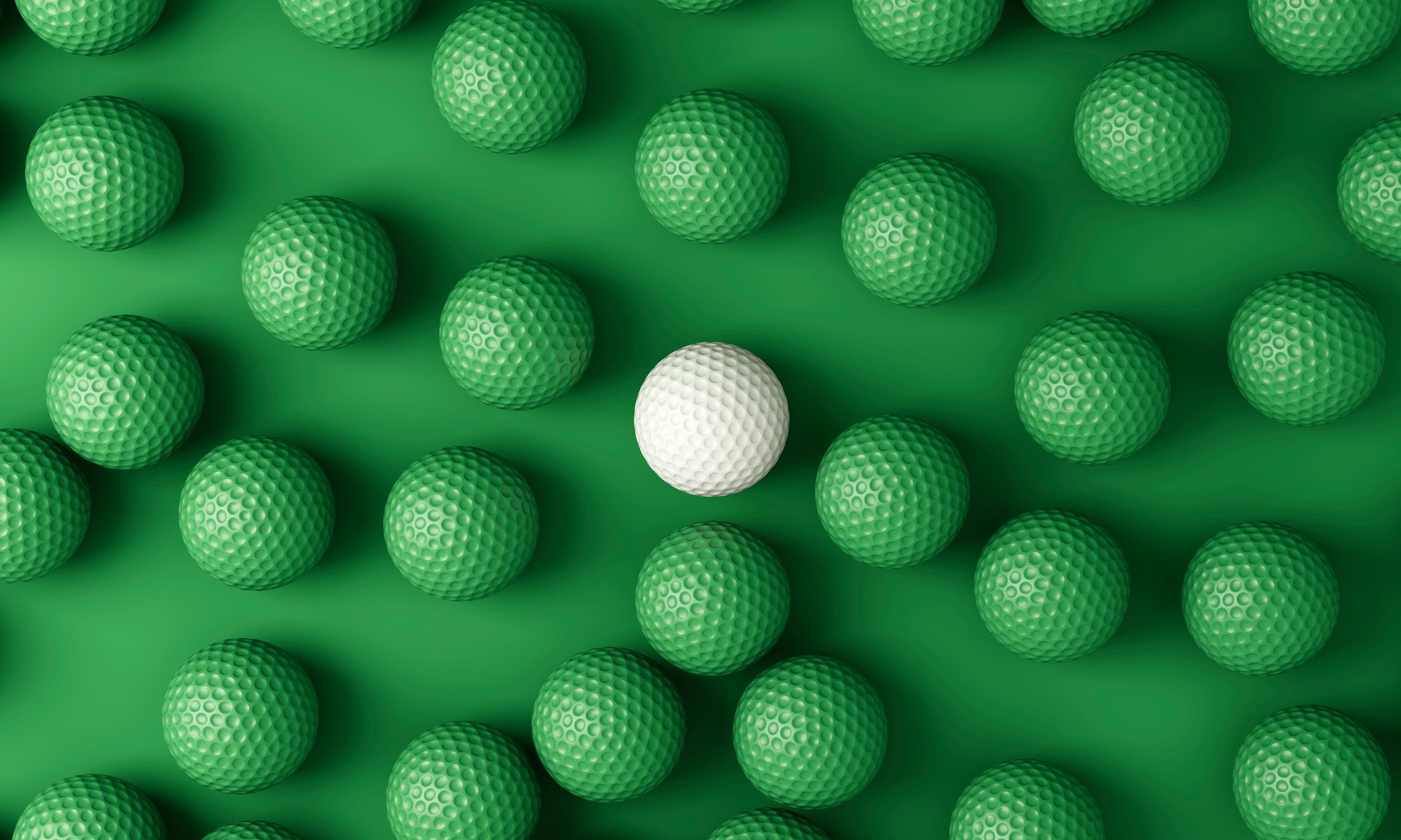 White golf ball among many green golf balls
